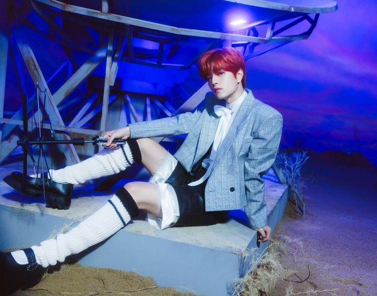 Seungmin wearing the outfit described in the post. He's sitting on a plinth with some kind of old tech satellite equipment (?) on it. His legs are arranged in such a way that he appears ready to be ravished. He's holding a random piece of tech junk in one hand and leaning his weight back on the other hand, just behind himself. His head is tilted slightly as he looks slightly up at the camera. His expression is a bit challenging. He knows he's hot and wants to know what you're going to do about it.