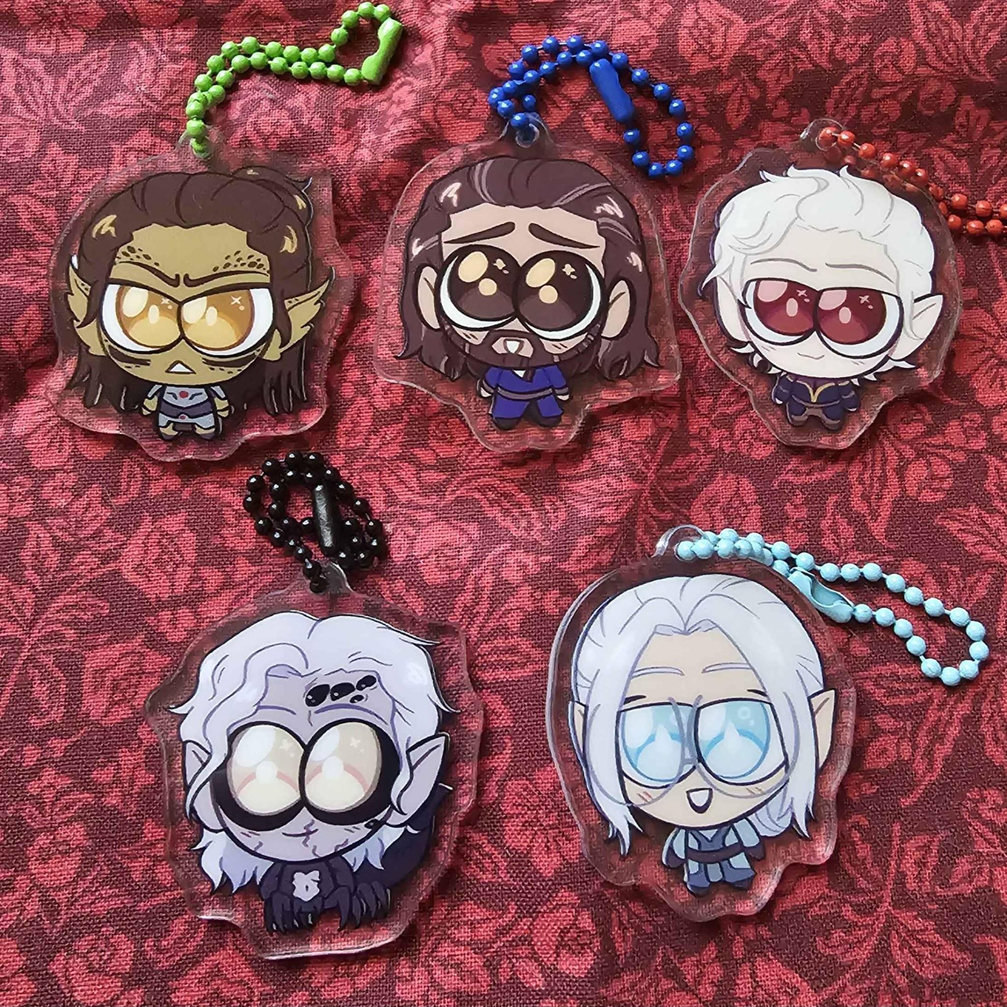 A set of chibi style acrylic charms, featuring the following Baldur's Gate 3 characters: Lae'zel, Gale, Astarion, Kar'niss, and my own Tav, Neuvaine.